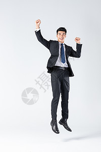 商务男士握拳跳跃背景图片