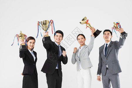 商务女性获奖胜利商务团队手拿奖杯背景