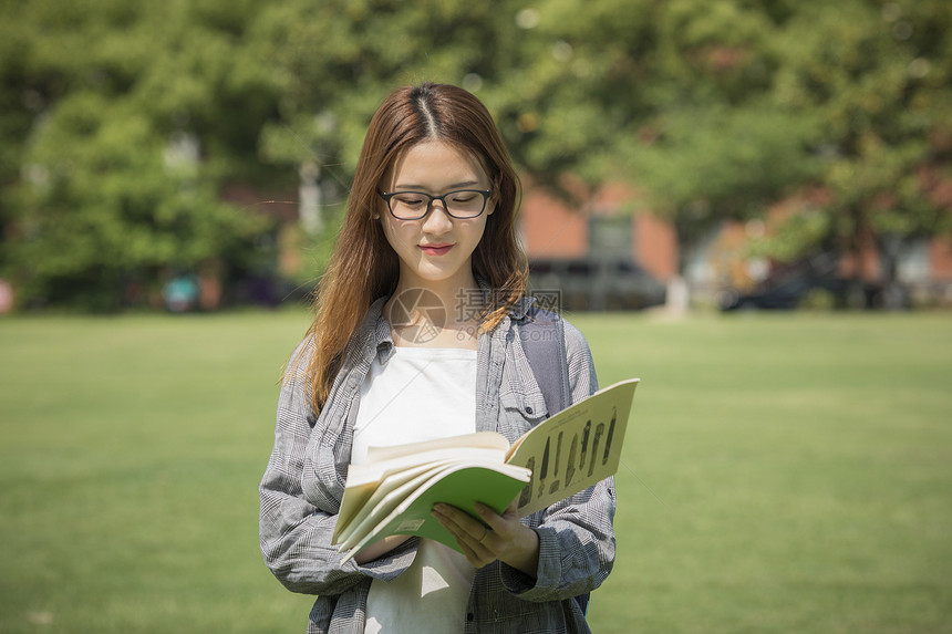 女学生在操场上看书图片