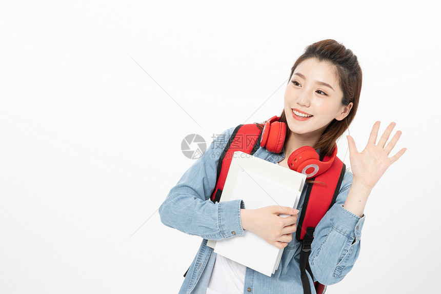 背书包打招呼的女大学生图片