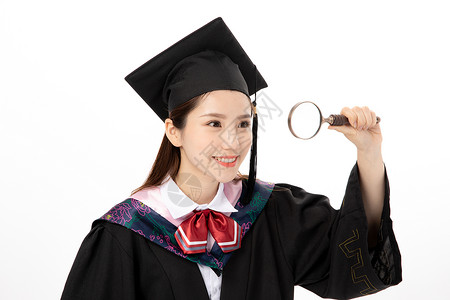 青年女性学士服手拿毕业证书手拿放大镜的毕业生背景