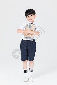 男生背着钱漫画抱着书本的儿童男孩背景