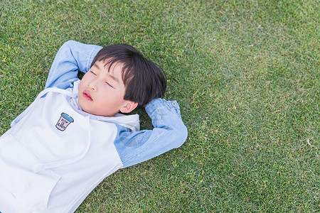 可爱儿童躺草地上休息图片