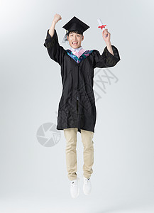 跳跃学士服男孩大学生毕业男性教育人像手举毕业证书背景