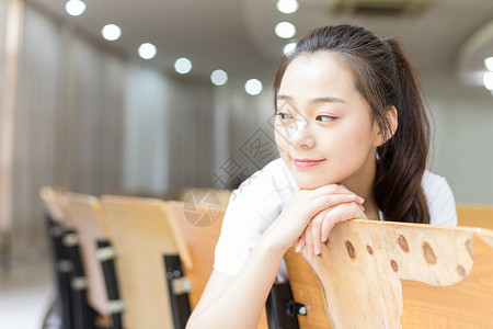 坐在教室里的甜美女生背景图片