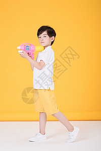 儿童小男孩手持玩具水枪背景图片