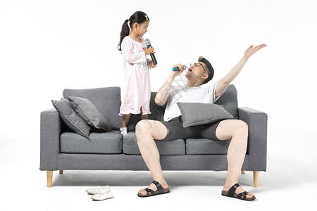 沙发上的父女爸爸和女儿在沙发上唱歌背景