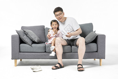 爸爸和女儿在沙发上看电视图片