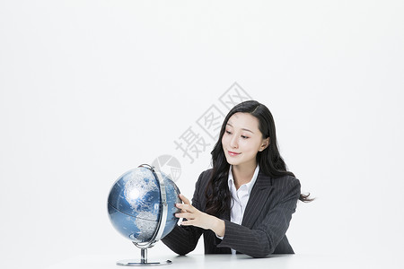 商务女性看着地球仪图片