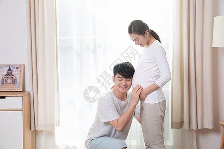 怀孕恩爱夫妻孕妇呵护背景