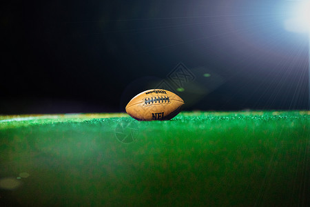 草地上的橄榄球背景图片