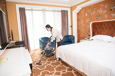 酒店客房吸尘器打扫卫生背景图片