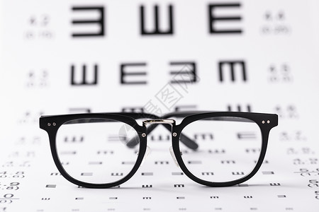 爱眼日宣传语眼镜与视力表背景