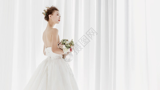 婚纱美女拿着捧花背景图片