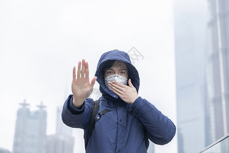 佩戴防尘口罩标志远离防尘雾霾背景