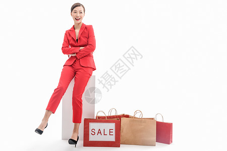 红西装女性购物促销背景图片