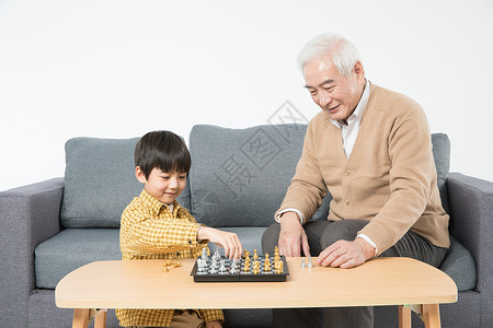 国际象棋儿童祖孙在沙发上下棋背景