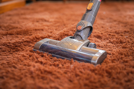 吸尘器清洁地毯特写高清图片