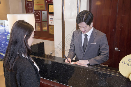 酒店服务员为客户办理入住住宿高清图片素材