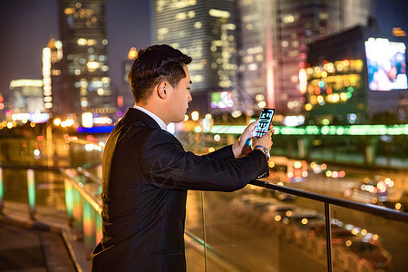 天桥栏杆年轻商务男子天桥玩手机背景