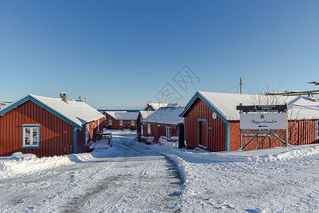 彩色雪花冬季北极圈中的彩色房子背景