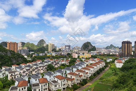 人造草地皮蓝天白云下的小区楼盘背景