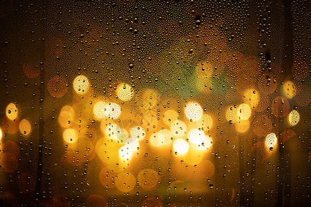 透过玻璃雨夜窗子光斑背景
