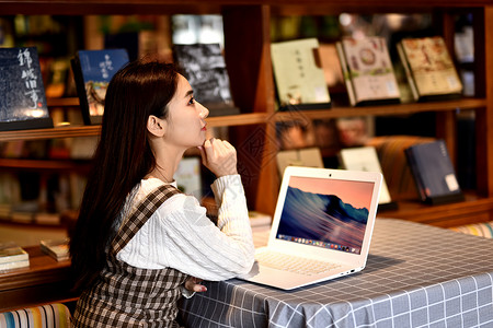 图书馆玩电脑的女生背景图片