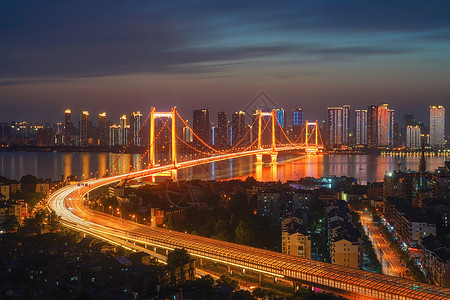 夜晚道路光照夕阳晚霞下的武汉鹦鹉洲大桥夜景背景