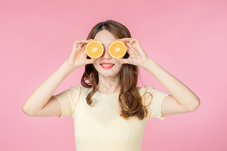 青年女性拿着橙子图片