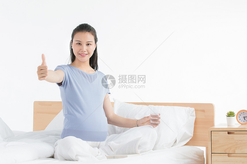 孕妇坐床上休息图片