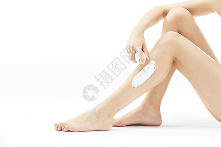 女性腿部涂抹脱毛膏特写背景图片