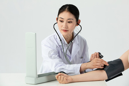 高血压人女性医生给患者量血压背景