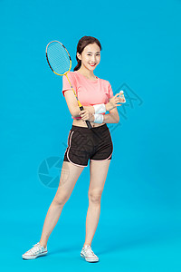 羽毛球女孩年轻女孩拿着羽毛球拍背景