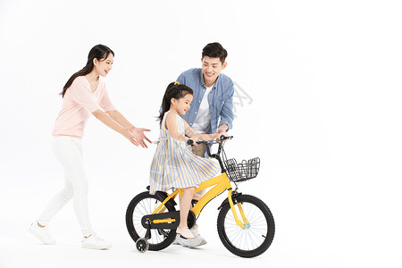 父亲教孩子骑车爸爸妈妈教女儿骑自行车背景