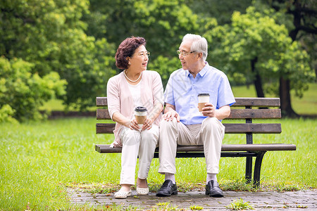 老年夫妇坐在公园长椅休息背景图片