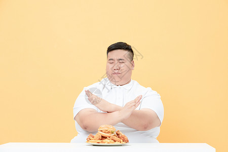 胖厨师青年肥胖男性拒绝炸鸡背景