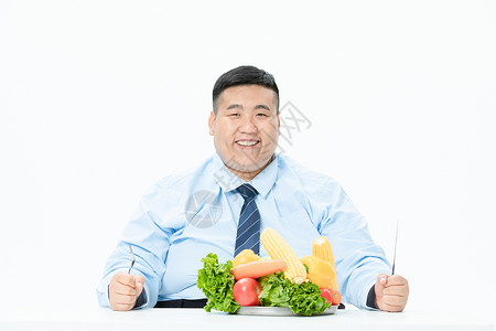 商务肥胖男性吃蔬菜图片