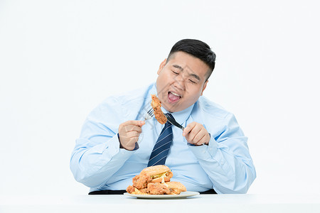 肥胖商务男性吃炸鸡图片