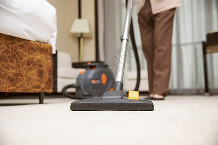 酒店管理保洁员吸尘器吸地毯高清图片