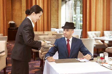 外国人服务酒店服务餐厅服务员给客人上菜背景