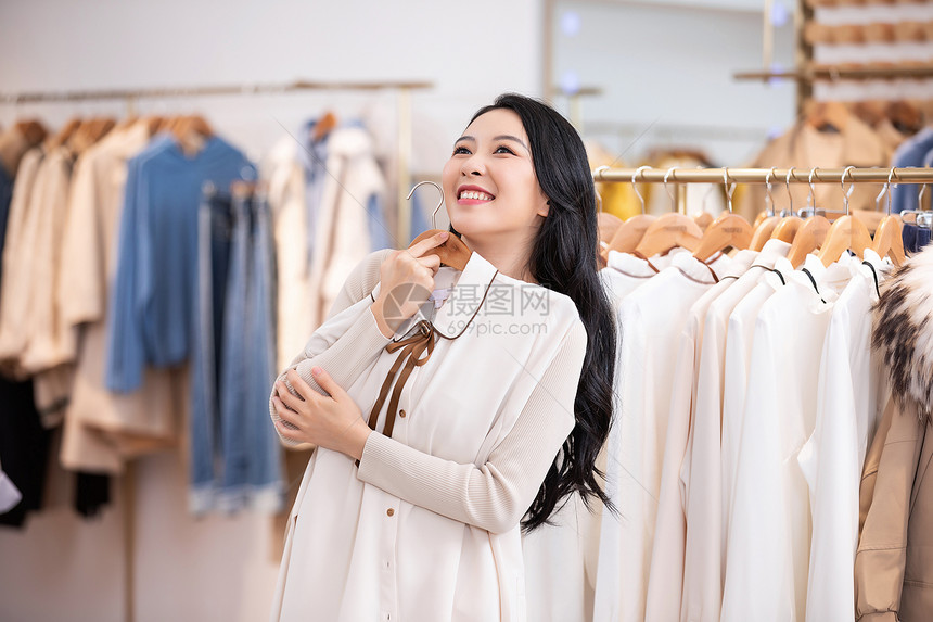 年轻美女商场购物挑选衣服图片