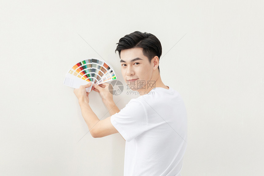 青年男性装修刷墙选油漆色卡色号图片