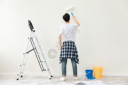 油漆装修海报青年男性装修刷墙背景