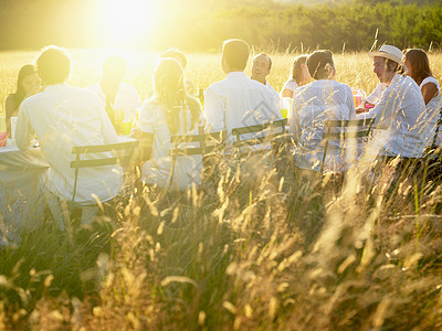 一群人在日落吃晚饭背景图片