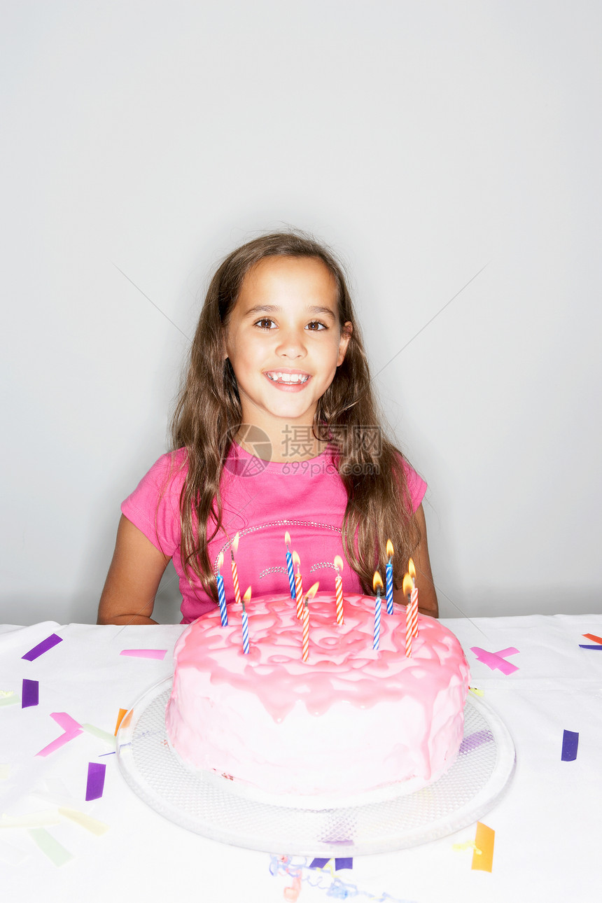 带生日蛋糕点燃蜡烛的女孩图片