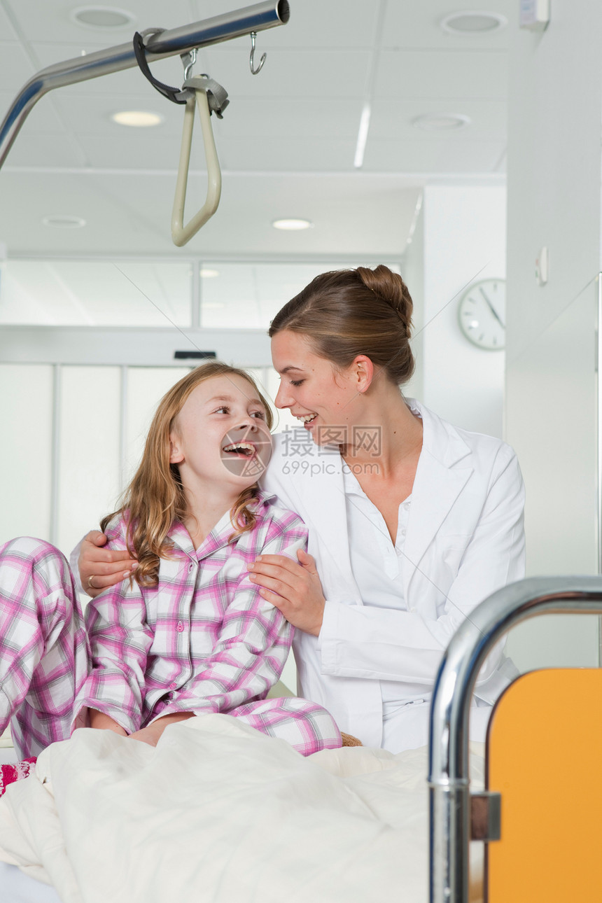 护士和女孩在医院的床上笑着图片