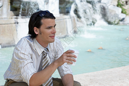 坐在喷泉边的商人高清图片
