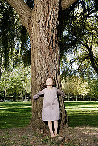 站在树旁的5岁女孩图片