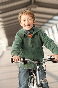 在城市里骑自行车的男孩图片